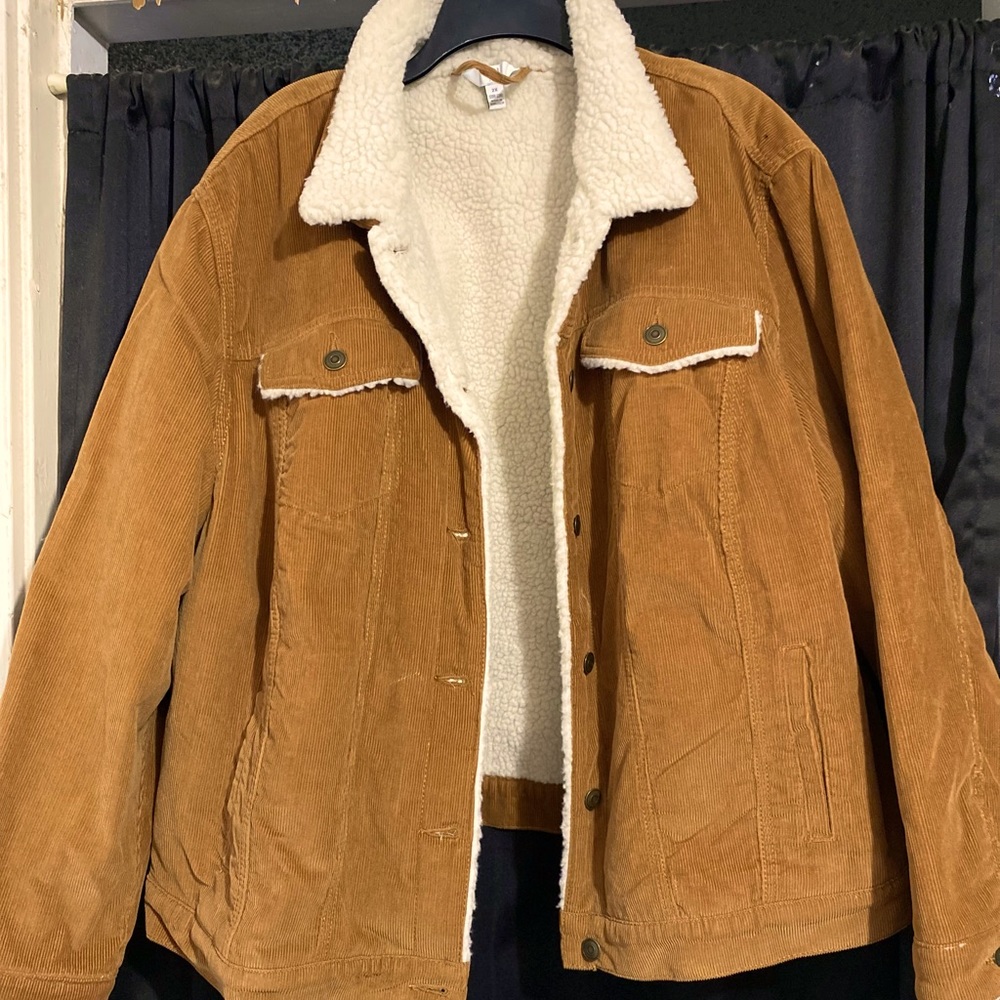 Outside brown, inside white teddy like material, four pockets on outside.